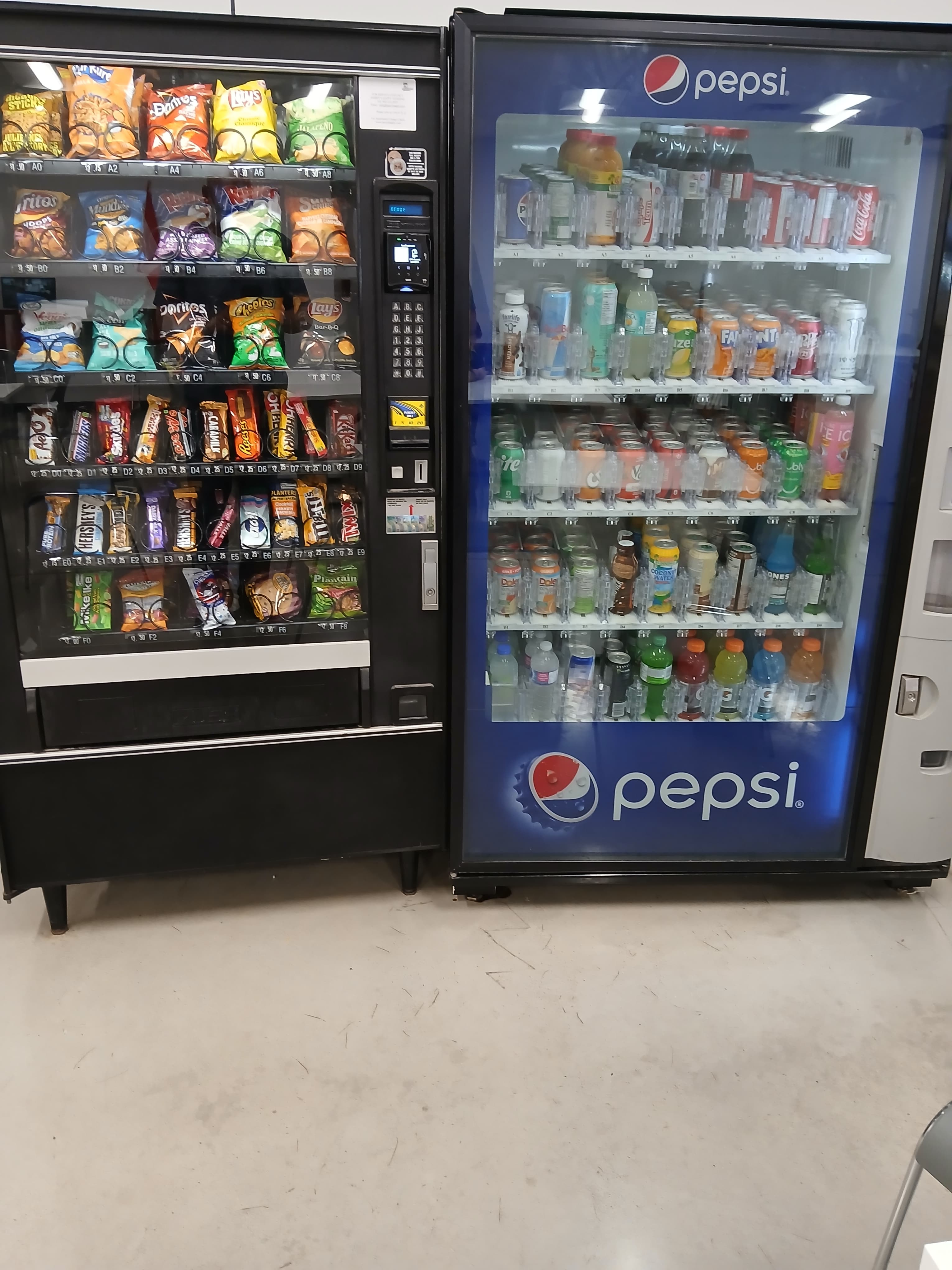 Row of snack and Pepsi beverage vending machines installed in a workplace break room by Harry's Happy Vending