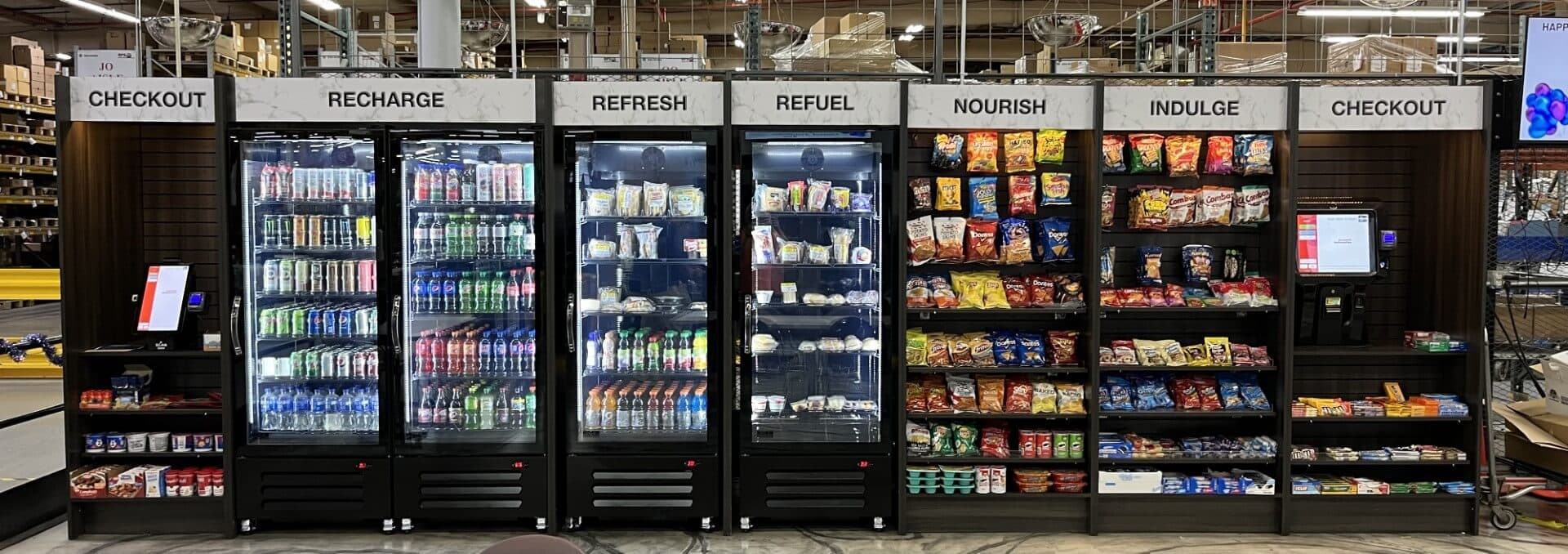 Open-concept micro market with self-checkout kiosks and refrigerated cases installed by Harry's Happy Vending
